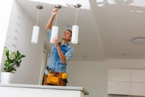 Electrician Fixing Light On Ceiling